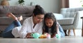 Indian mommy child daughter playing tea party using toy teaset