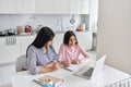 Happy young indian mother helping teen daughter studying at home. Royalty Free Stock Photo