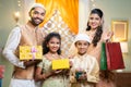 Happy young indian muslim family celebrating and enjoying ramdan festival by shopping online during offer sales - Royalty Free Stock Photo