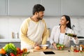 Happy young indian vegetarian couple cooking together at home Royalty Free Stock Photo