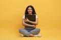 Happy young indian woman hugging laptop with blank screen Royalty Free Stock Photo