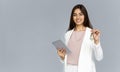 Happy young indian woman professional realtor looking at camera holding key