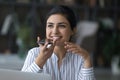 Happy young Indian woman recording audio message on cellphone. Royalty Free Stock Photo