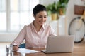 Happy young Indian woman working on laptop at home Royalty Free Stock Photo