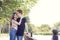 Happy young inlove couple talking a walk in the park near a lake