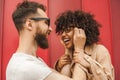 happy young interracial couple in eyeglasses having fun together