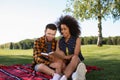 Happy young interracial couple reading book outdoors Royalty Free Stock Photo