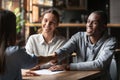 Happy interracial couple handshake bank manager take mortgage loan Royalty Free Stock Photo