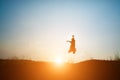 Happy young kids jumping against beautiful sunset. Royalty Free Stock Photo