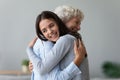 Happy young granddaughter embracing hugging old retired grandmother cuddling Royalty Free Stock Photo