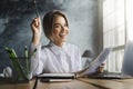 Happy young lady sitting at desk and studying. Student preparing for college classes. Distant education.