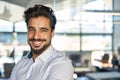 Happy young Latin business man looking at camera in office, headshot portrait. Royalty Free Stock Photo