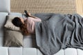 Happy young latin lady lying resting on couch watching tv Royalty Free Stock Photo