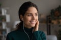 Happy young Latin woman listen to music in headphones Royalty Free Stock Photo