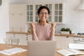 Happy young latina woman celebrate receiving amazing offer by laptop