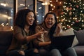 happy young lesbian gay couple at christmas making a family video call on a laptop, lgbt or lgbtq marriage having a good time at