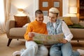 Happy young lesbian woman couple looking at paper map planning trip Royalty Free Stock Photo