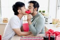 Happy young LGBT couple sharing special moment together on Valentine Day, Asian gay male lover kissing kissing behind red heart to