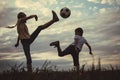 Happy young little boy and girl playing in the field  with soccer ball Royalty Free Stock Photo