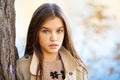 Happy young little girl in beige coat