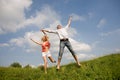 Happy Young love Couple - jumping under blue sky Royalty Free Stock Photo