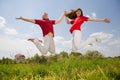 Happy Young love Couple - jumping under blue sky Royalty Free Stock Photo