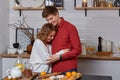 Happy young lovely couple on kitchen hugging each other. They enjoy spending time togehter Royalty Free Stock Photo
