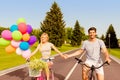 Happy young lovely couple in love cycling and holding hands Royalty Free Stock Photo