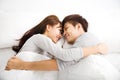 Happy young lovely couple lying in a bed Royalty Free Stock Photo