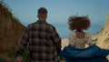 Young lovers running ocean beach. Attractive girl waves hair holding guy hand. Royalty Free Stock Photo