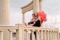 Young loving couple embracing each other outdoors in the park holding balloons Royalty Free Stock Photo