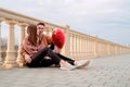 Young loving couple embracing each other outdoors in the park holding balloons Royalty Free Stock Photo