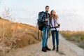 Happy young loving couple outside with backpack in free alternative vacation camping Royalty Free Stock Photo