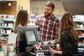 Happy young loving couple standing near cashier`s desk Royalty Free Stock Photo