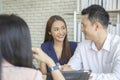 Happy young loving couple talking to their real estate agent with smile looking at house , Planning for the future of the family