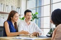 Happy young loving couple talking to their real estate agent with smile looking at house , Planning for the future of the family Royalty Free Stock Photo