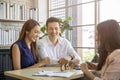 Happy young loving couple talking to their real estate agent with smile looking at house   Planning for the future of the family Royalty Free Stock Photo