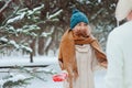 Happy young loving couple walking in snowy winter forest, covered with snow Royalty Free Stock Photo