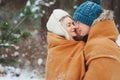 Happy young loving couple walking in snowy winter forest, covered with snow Royalty Free Stock Photo