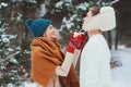 happy young loving couple walking in snowy winter forest, covered with snow and hug Royalty Free Stock Photo