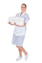 Happy young maid holding towels Royalty Free Stock Photo