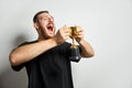 Happy young male or businessman holding his gold trophy and celebrating victory. Studio shot of man with cup as winner Royalty Free Stock Photo