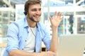 Happy young male customer support executive working in office