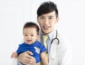 young male doctor holding a baby boy Royalty Free Stock Photo