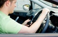 Happy young male driver sitting in a car Royalty Free Stock Photo