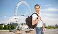 Happy young man with backpack and book travelling Royalty Free Stock Photo