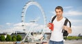 Happy young man with backpack and book travelling Royalty Free Stock Photo