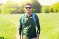 Happy young man with backpack hiking outdoors Royalty Free Stock Photo