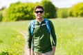 Happy young man with backpack hiking outdoors Royalty Free Stock Photo