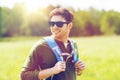 Happy young man with backpack hiking outdoors Royalty Free Stock Photo